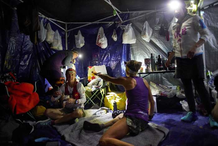 Between laps, runners eat, hydrate and stretch.